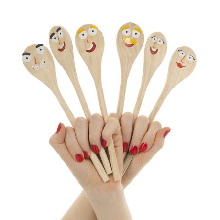 Funny wooden spoons in hands isolated over white backgroundの写真素材