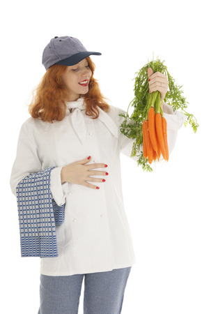 Female cook chef with red hair and baked bread  isolated over white backgroundの写真素材