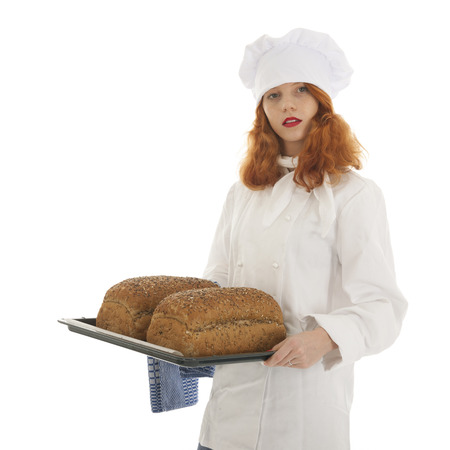 Female baker chef with red hair and baked bread  isolated over white backgroundの写真素材