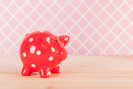 Funny red piggy bank in pink interiorの写真素材
