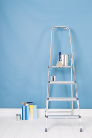 Painting the interior with tins and brushes on stepladderの写真素材