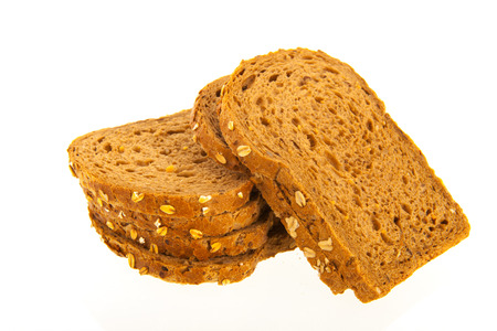 Stacked wholemeal slices of bread isolated over white background