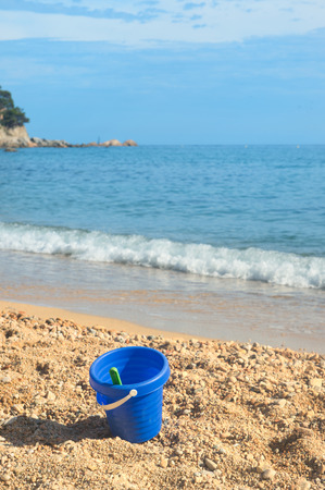 Plastic toys in sand at the beachの写真素材