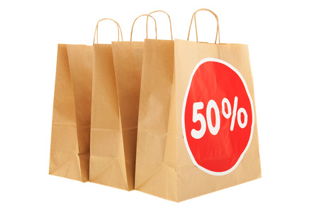 Brown paper shopping bags with 50% discount isolated over white backgroundの写真素材