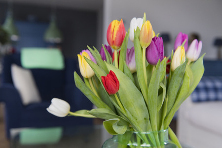 Colorful vase with bouquet tulips in interiorの写真素材