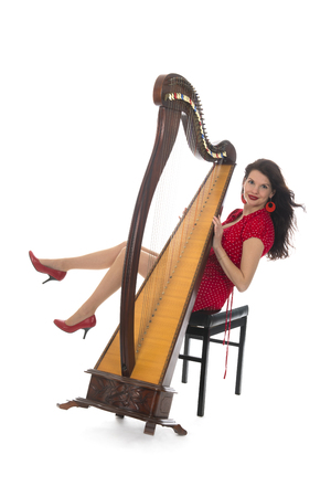 Young attractive woman in red with decachord instrument isolated over white background