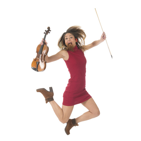 Young woman jumping high with violin music instrument isolated over white backgroundの写真素材