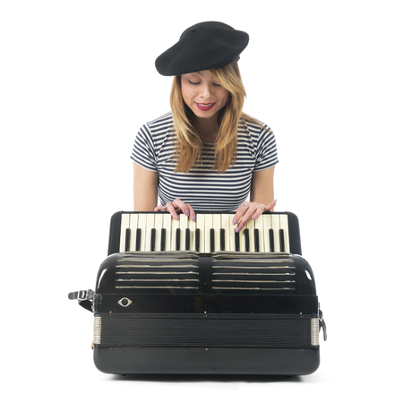 French girl making music with accordion instrument isolated over white backgroundの写真素材