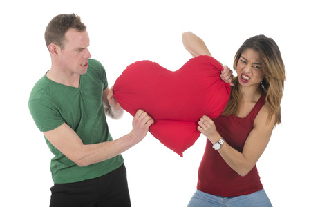 Young couple fighting for the heart of loveの写真素材