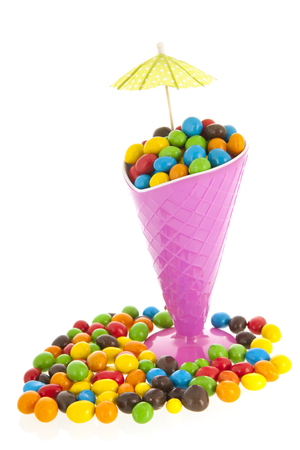 Colorful party candy in cup isolated over white backgroundの写真素材