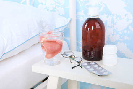 Blue bedroom with bed glasses and glass water and wall paper