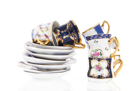 Stacked cups and saucers isolated over white backgroundの写真素材