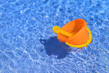 Plastic child toys floating in the swimming pool outdoorの写真素材