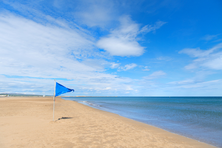 Blue safety flag on Gruissan plage in French languedoc-Roussillonの写真素材