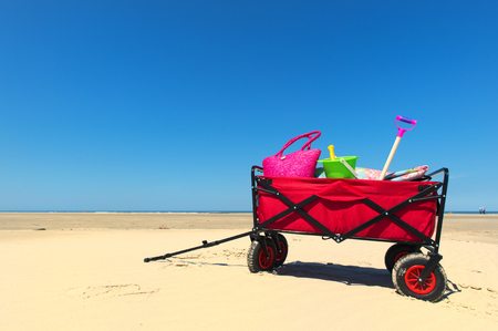 Hand cart with vacation luggage at the beachの写真素材