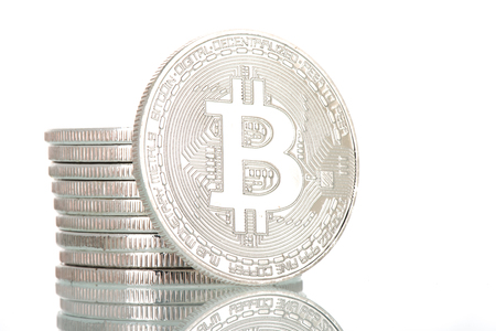 Stacked silver bitcoins isolated over white backgroundの写真素材
