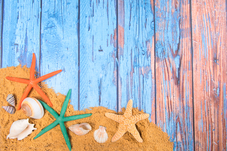 Beach poster on wooden background with starfishes and life buoyの写真素材