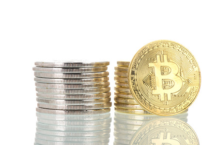 Stacked silver and golden bitcoins isolated over white backgroundの写真素材