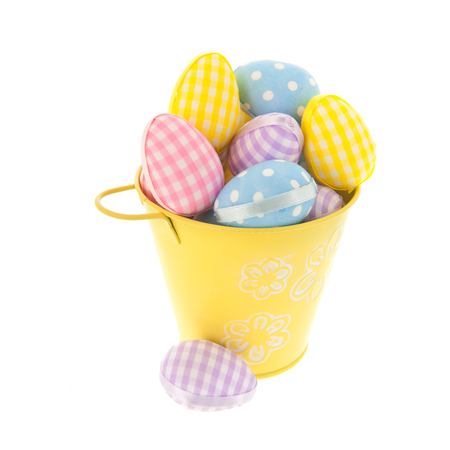 Full pastel colored easter eggs in bucket isolated over whiteの写真素材