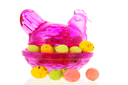 Pink glass easter chicken with little easter eggsの写真素材