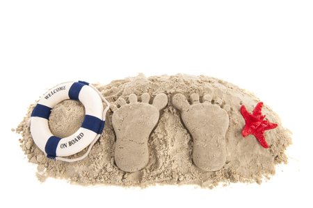 Feet prints at the beach isolated over whiteの写真素材