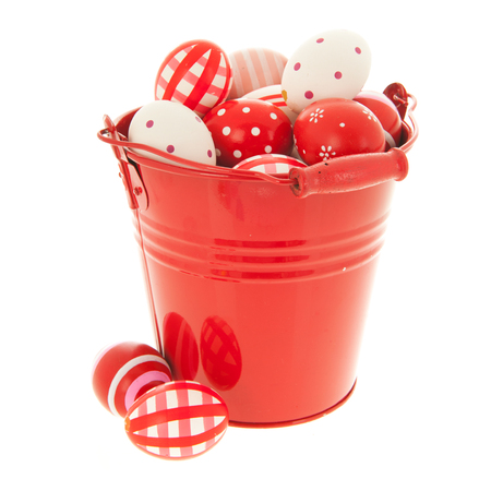 Full red easter eggs in bucket isolated over whiteの写真素材