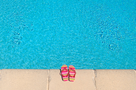 Colorful striped flip flops at the swimming poolの写真素材