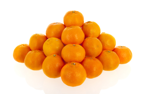 Pyramid from orange mandarins isolated over whiteの写真素材