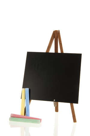 Empty black board with chalk isolated over whiteの写真素材