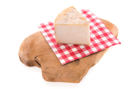 Piece goat cheese on wooden cutting boardの写真素材