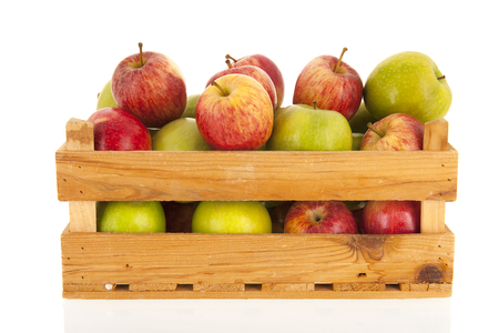 Crate fresh green and red apples isolated over white backgroundの写真素材