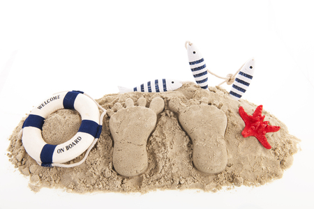 Feet prints at the beach isolated over whiteの写真素材