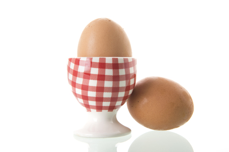 Chicken egg in red and white checkered cupの写真素材