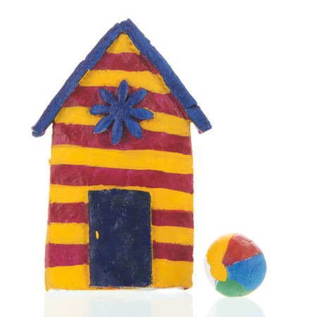 Colorful handmade beach cabin from clay isolated over whiteの写真素材