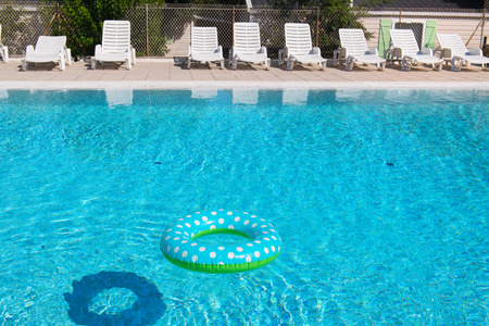 Spotted blue inflatable ring in swimming poolの写真素材