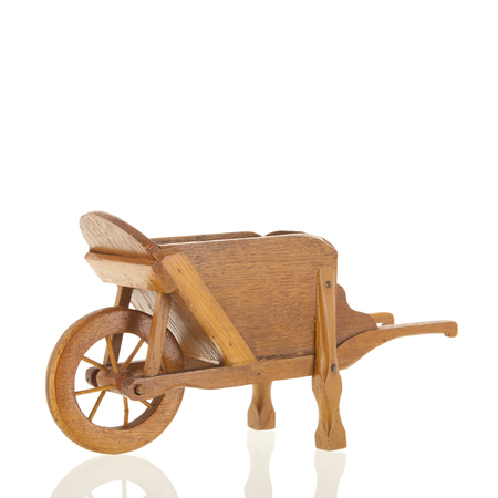 Vintage classic wooden wheel barrow isolated over white backgroundの写真素材