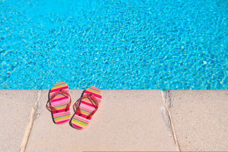 Colorful striped flip flops at the swimming poolの写真素材