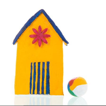 Colorful hand made beach cabin and toy ball isolated over white backgroundの写真素材
