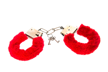 Erotic Sex toy as red hand cuffs isolated over white backgroundの写真素材