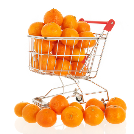 Shopping cart with mandarins isolated over white backgroundの写真素材
