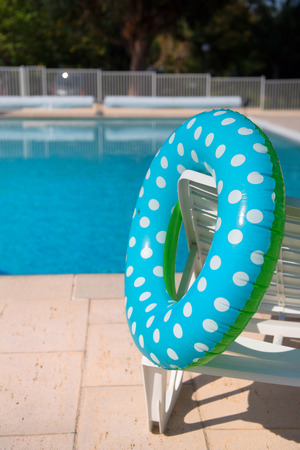 Spotted blue inflatable ring in swimming poolの写真素材
