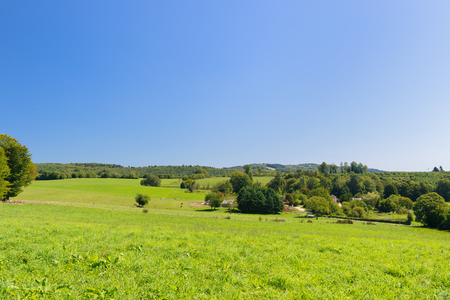 Typical French village with houses and pasturesの写真素材