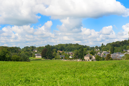 Typical French village with houses and pastures in green hills in Franceの写真素材