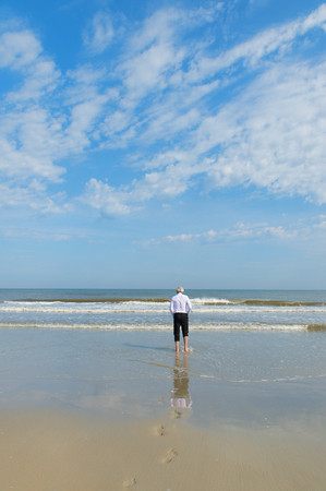 Business man in formal suit walking in the seaの写真素材