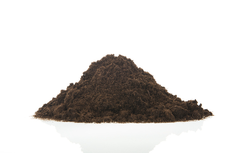 Black heap sand isolated on whiteの写真素材