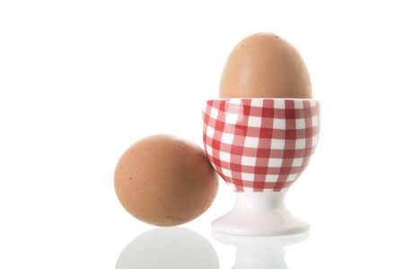 Chicken egg in red and white checkered cupの写真素材