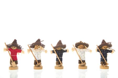 Row colorful scarecrows isolated over whiteの写真素材