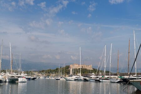 Boats in the harbor of Antibes with fort carreの写真素材