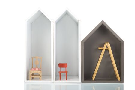 Three simple white houses with furniture in a row isolated over whiteの写真素材