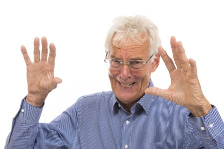 Portrait scaring senior man isolated against white backgroundの写真素材